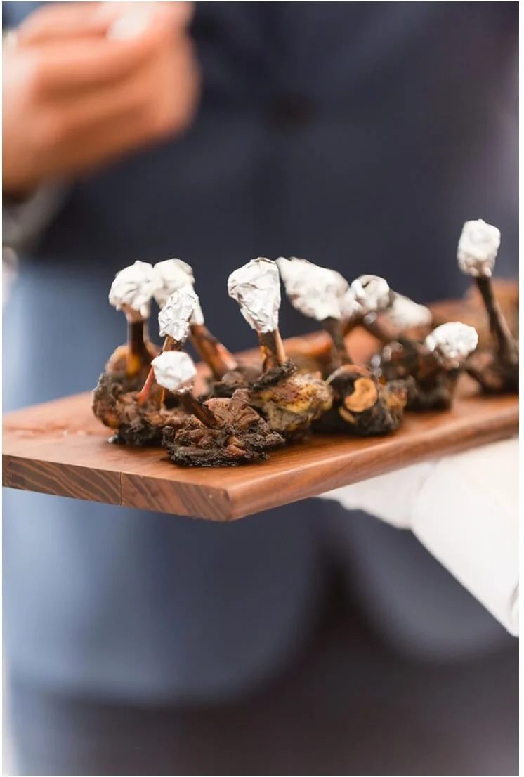 Jerk lamb lollipops passed on a wooden board