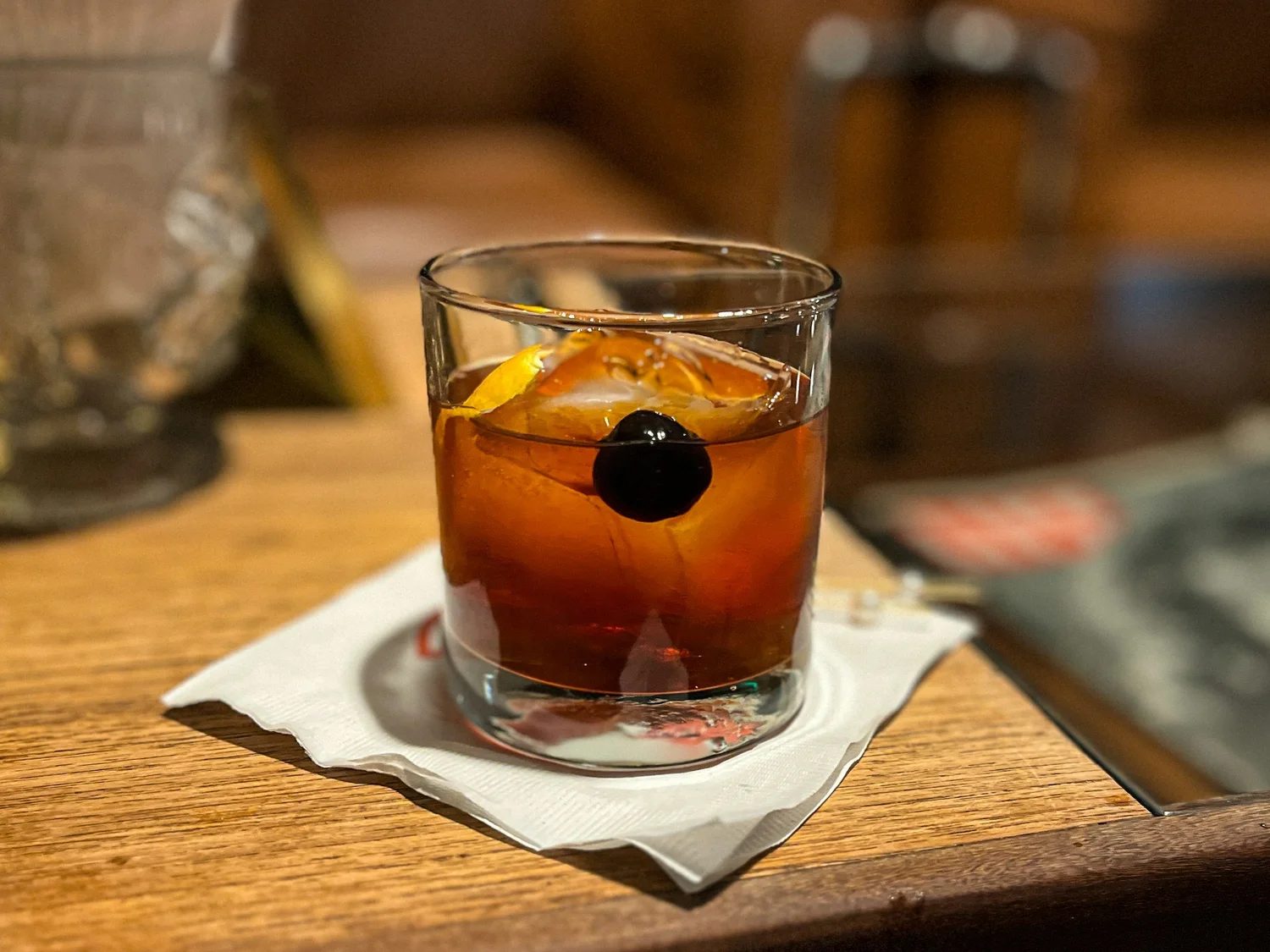 An old fashioned cocktail on a wooden bar