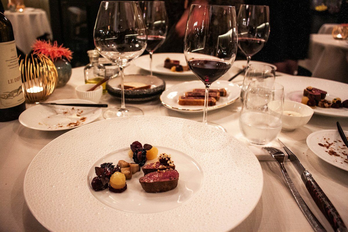 A plated dinner course on a candlelit table