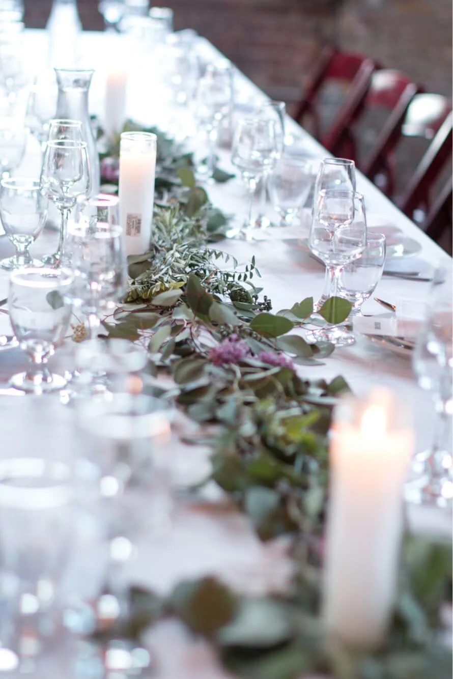 A long table with garland and candles